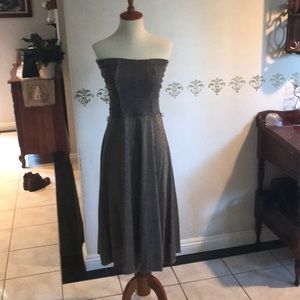 Strapless sparkly dark gold stretchy dress, bust on dummy is 33”, waist is 26”.
